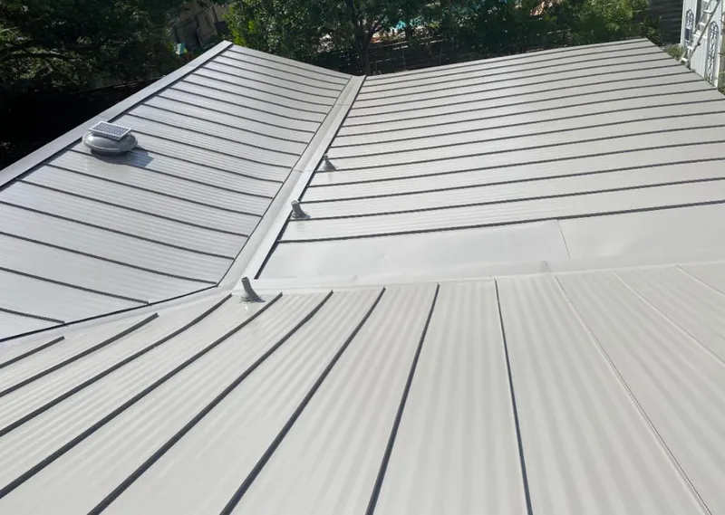 Solar attic fan installed on a metal roof for Roof Ventilation in Brent